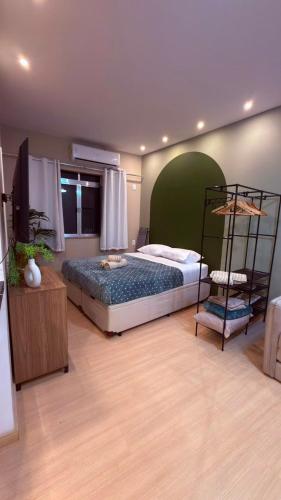 a bedroom with a bed with a green headboard at Studio no Centro do Rio l Próximo ao Metrô e VLT in Rio de Janeiro