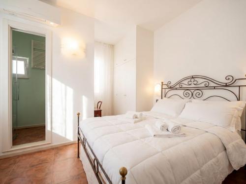 a bedroom with a large white bed in a room at Dimora BoxFish - Panorama terrace in Polignano a Mare