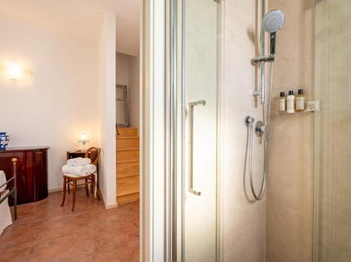 a bathroom with a shower with a glass door at Dimora BoxFish - Panorama terrace in Polignano a Mare