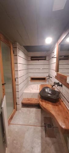 a small bathroom with a sink and a bed at Ocres de mi Tierra in Tilcara
