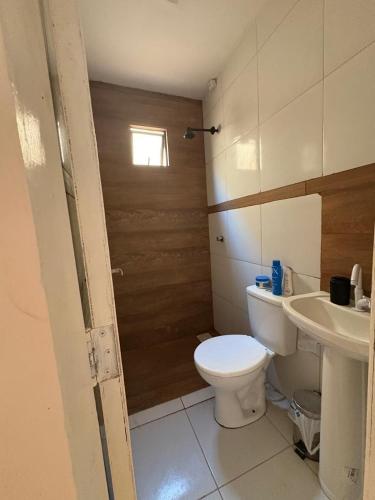 a bathroom with a toilet and a sink at Casa TS Morro Branco in Beberibe