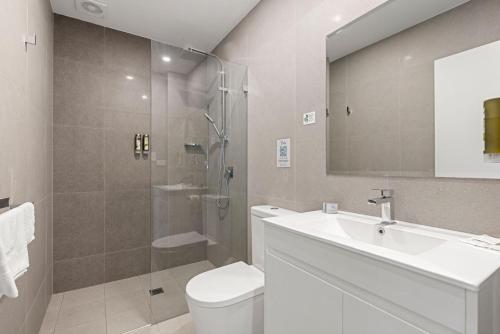 a bathroom with a toilet and a sink and a shower at Modern Queen Studio - 6 Mins to Callala Beach in Callala Beach