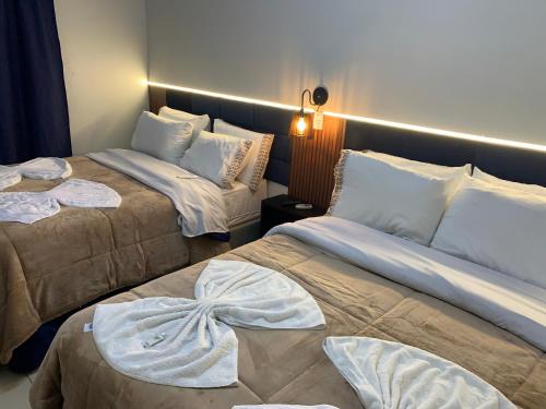 a room with two beds in a room at Pousada HG-102-Suíte in Vila Nova do Sul