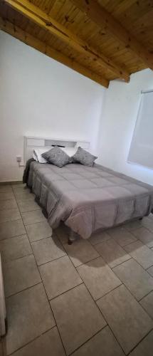 a large bed in a white room with at Depto El Mirador in Plaza Huincul
