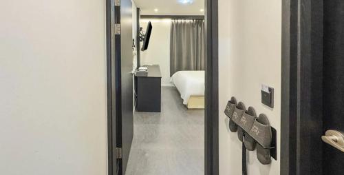 a view of a room with a bed and a mirror at Hotel Barley Field Seoknam in Incheon