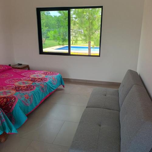 a bedroom with a bed and a window at Quinta Bello Cielo in Montemorelos