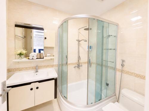 a bathroom with a shower and a sink at Valoria Legend Hanoi Hotel in Hanoi
