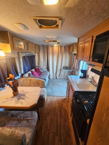 a living room with a couch and a table in a caravan at Casa Rodante Tony 1 in San Felipe