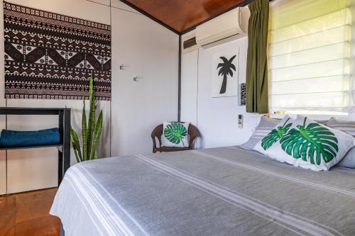 a bedroom with a bed and a window at Ariki Retreat - Adults Only in Rarotonga