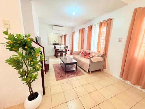 a living room with a couch and a table at Casa Tranquila Panglao in Dauis