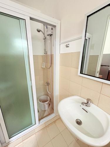 a bathroom with a sink and a shower at Casa Tranquila Panglao in Dauis