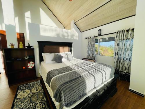 a bedroom with a large bed and a window at Moon Mist Villa- Hatton in Hatton
