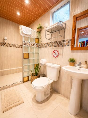 a bathroom with a toilet and a sink at La Casa del Molino Blanco B&B in Baños