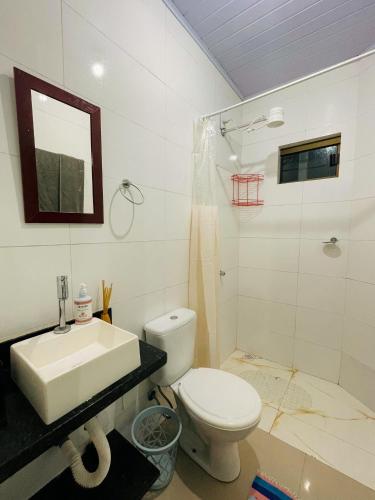 a bathroom with a toilet and a sink and a shower at Casa Vilarejo São Jorge in Sao Jorge