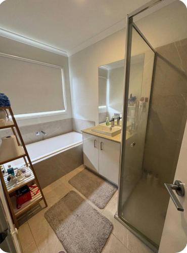 a bathroom with a shower and a sink and a tub at Cozy and comfortable room - Geelong suburbs in Grovedale