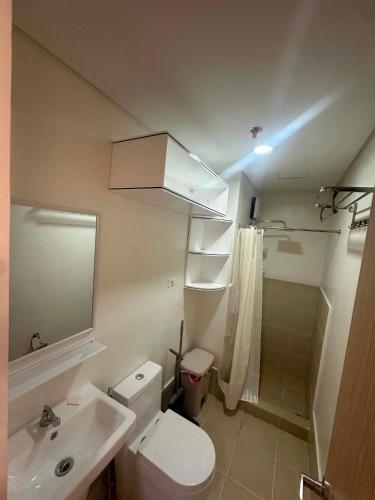 a bathroom with a toilet and a sink and a shower at Leaf residences 2bedroom Muntinlupa in Manila