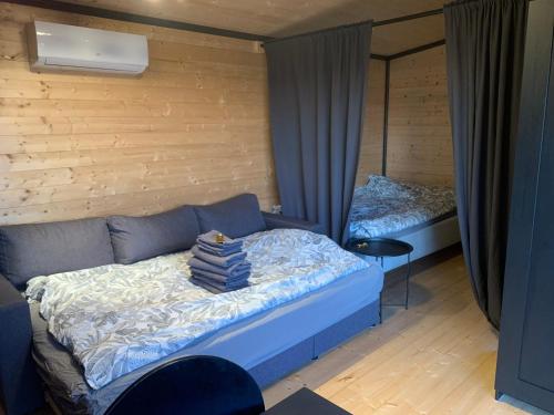 a bedroom with a bed and two beds in it at Cottage with sauna and kayaks in Hammarland