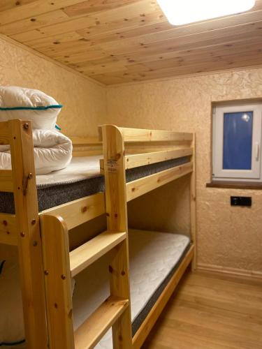 a room with bunk beds in a tiny house at Silumetras in Ventspils