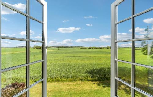 an open window looking out at a green field at Nice Home In Idestrup With Wifi in Idestrup