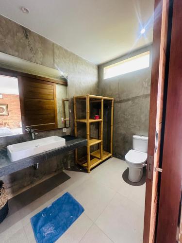 a bathroom with a sink and a toilet at The balangan studio room 7 in Bingin Beach