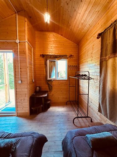 a room with a wooden room with a bench and a window at SWEEPH in Mestia