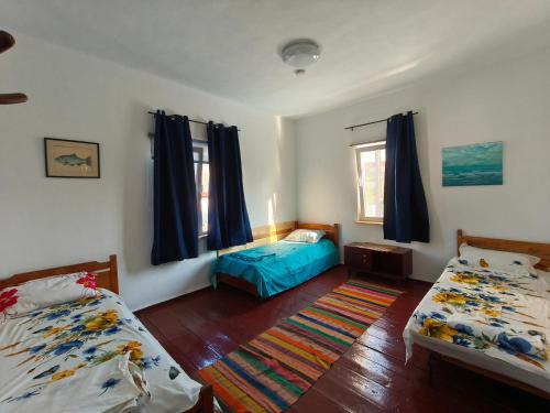 a bedroom with two twin beds and a blue bed at Stufstock Hostel in Sulina