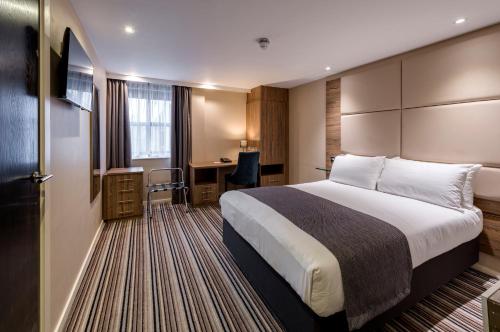 a hotel room with a bed and a desk at Holiday Inn York City Centre by IHG in York