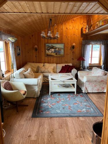 a living room with a couch and a table at Skjevlingsnes sjøhus in Tingvoll