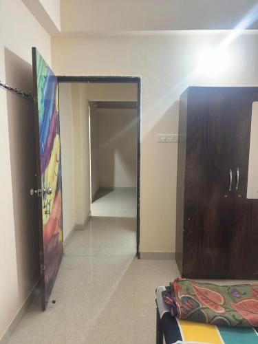 a room with a door leading to a closet at Suyakshi homestay in Pune