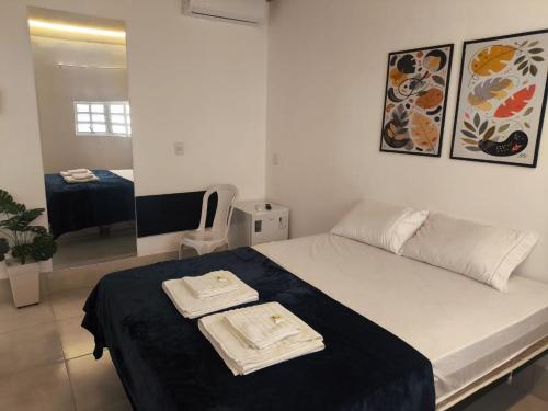 a bedroom with a bed with two towels on it at Gyn Suítes - Suítes novas e funcionais in Goiânia