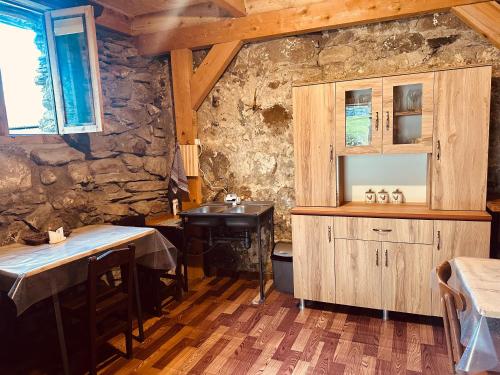 a kitchen with a sink and a table in a room at SWEEPH in Mestia