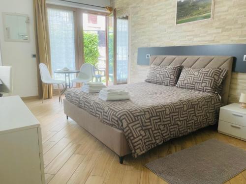 a bedroom with a bed and a table and chairs at Il Vigneto Rooms & Breakfast - Valtellina Panoramic View in Castione Andevenno