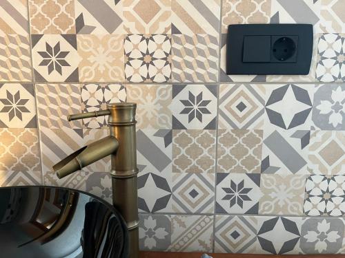 a bathroom with a sink and a tile wall at Apartment Lagma in Železniki