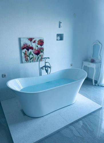 a white bath tub in a bathroom with a sink at Villa Vuk in Budva
