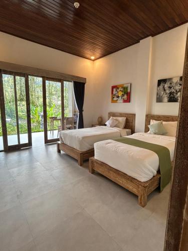 two beds in a room with windows at Chez Lepusa in Sidemen