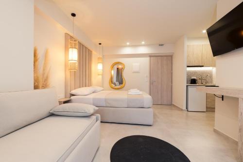 a hotel room with two beds and a couch at MaDaM Essence in Nei Poroi