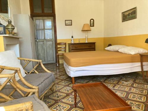 a bedroom with a bed and a chair and a table at Quiet, fresh, and nice in Letia