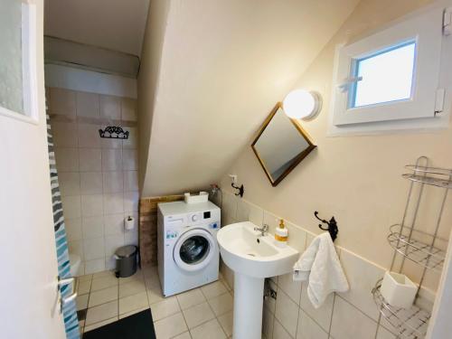 a bathroom with a washing machine and a sink at Island Traditional House in Poros
