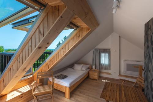 a bedroom with a bed under the stairs at Bleicher Borbirtok in Balatonkeresztúr