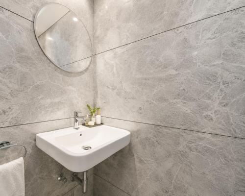 a bathroom with a sink and a mirror at Hotel Evanka Brilliant Convention in Indore