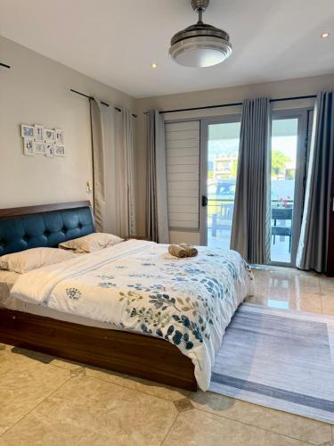 a bedroom with a large bed and a large window at Bountiful Estates Fantasy in Nadi