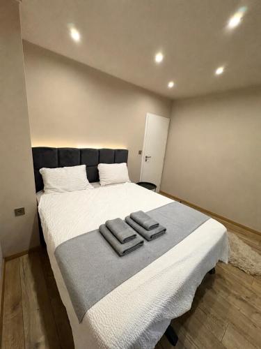 a bedroom with a large bed with two towels on it at Urban Apart in Stara Zagora