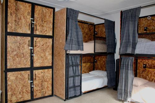 two bunk beds in a room with sliding doors at Luffa Hostel in Santa Lucía
