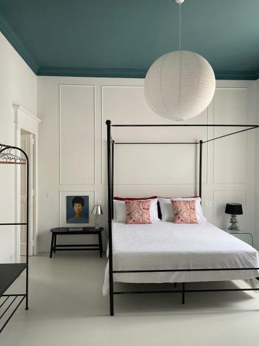 a bedroom with a bed with a lamp and a table at Casa Margo in Campobasso