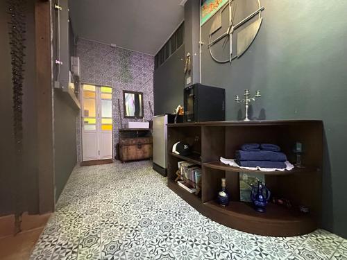 a bathroom with a sink and a mirror and a hallway at 385 Homestay & Lake camp in Ban Khai Nao (1)