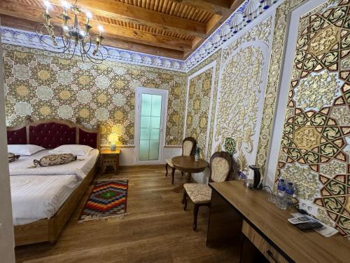 a bedroom with a bed and a table and chairs at Central Asia in Bukhara