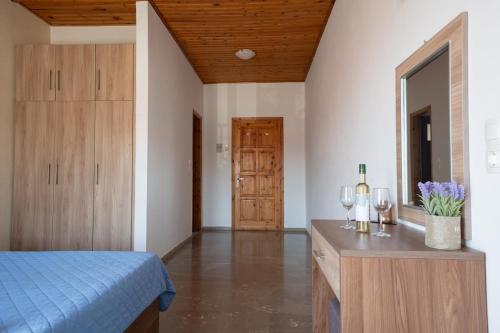 a bedroom with a bed and a table with wine glasses at Ser Rooms 05 in Petra