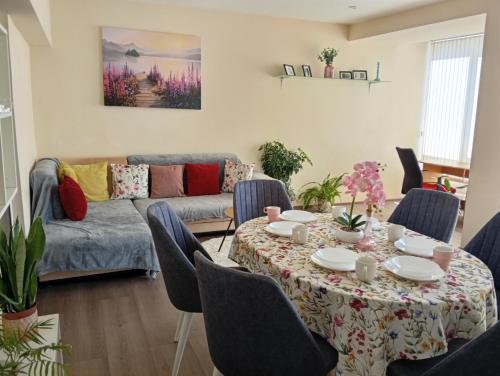 a living room with a table and a couch at Grand Central Varna in Varna City