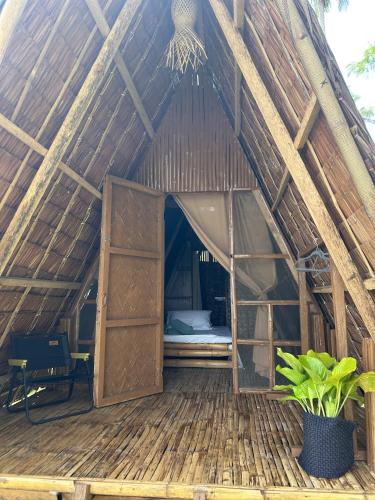 a large wooden house with a bed in the middle at Lumindas Beach Resort in Sabang