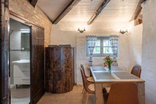 a dining room with a wooden table and a sink at Bleicher Borbirtok in Balatonkeresztúr
